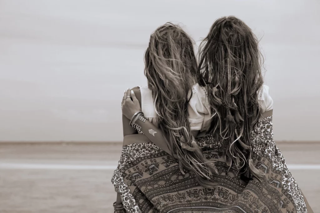 ToF Fotobehang bohemian twee mooie boho-meisjes die naar zee kijken